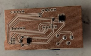 Milled copper surface of one-layer PCB with surface mount components on a countertop